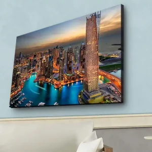 Canvastavla med LED-belysning - Storslagen vy över en modern stad med glittrande skyskrapor och en slingrande flod Blå / Orange / Grå - Inredning Rea