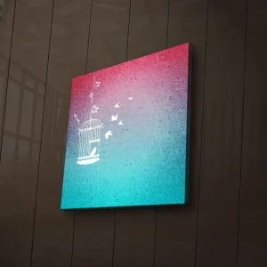 Canvastavla med LED-belysning 28x28 cm - Fängslande fågelbur med flygande fåglar i en drömlik bakgrund Rosa / Turkos - Inredning Erbjudandepris